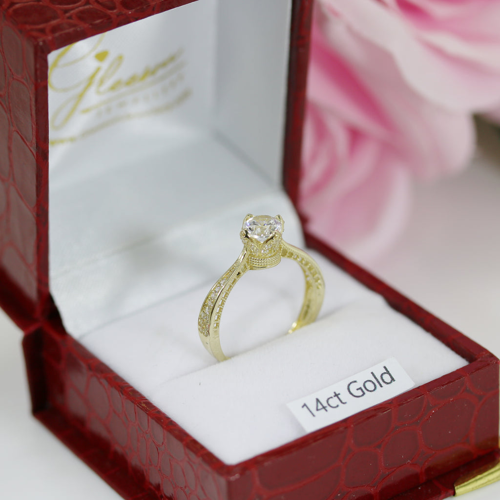 Macro shot of the crown-inspired 14ct gold CZ ring showing detailed band engravings within a Gleeson Jewellers box.