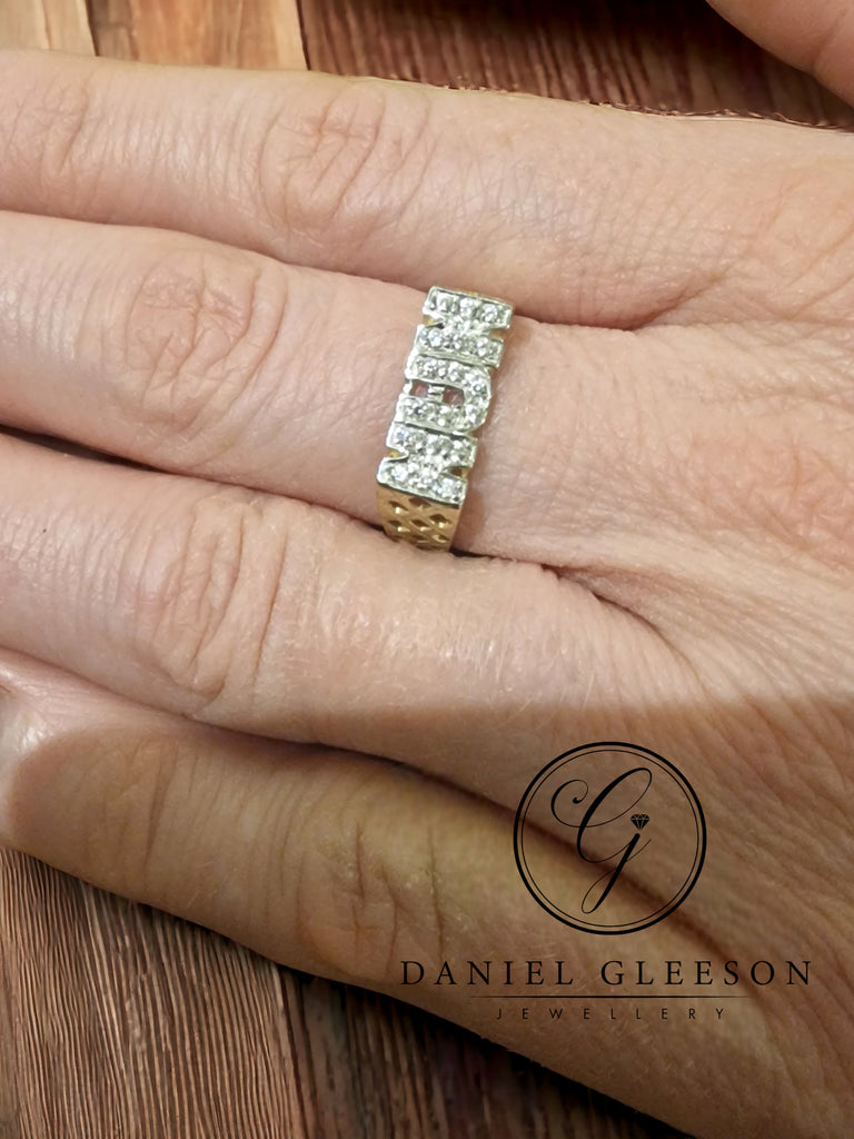 Elevate your style with the 9ct Gold nan ring from Daniel Gleeson Jewellers Cork, beautifully displayed on a hand. Adorned with sparkling cubic zirconia, this ring is a timeless tribute to grandmotherly love and grace. Explore our collection and embrace the sentimentality of Daniel Gleeson Jewellers Cork