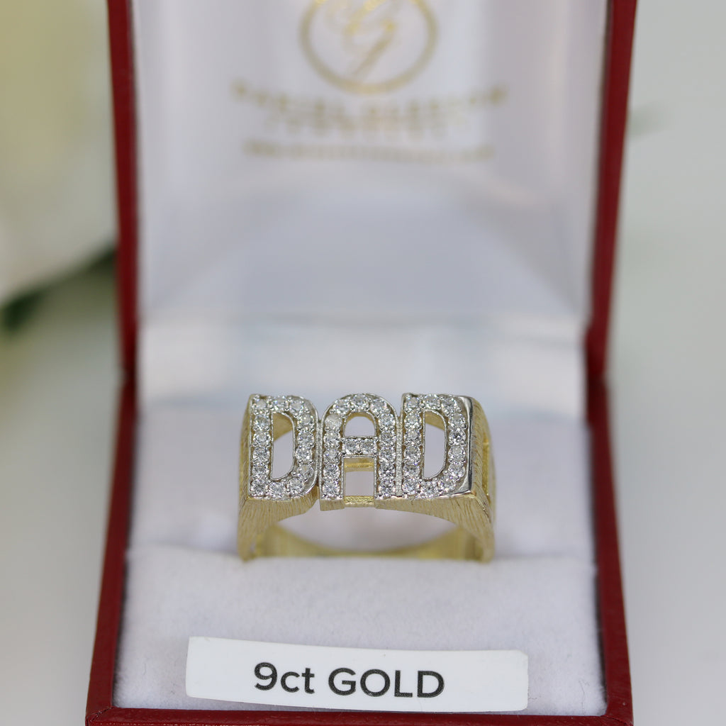 Close-up of the 9ct Gold DAD Ring in a jewellery box – The ring features large block DAD initials set with cubic zirconia, with open linked design sides, displayed in an elegant jewellery box.