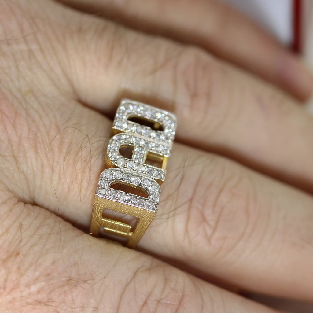 DAD Ring worn on a hand – The 9ct gold ring is shown on a wearer’s finger, highlighting its bold design, sparkling cubic zirconia initials, and open linked sides.