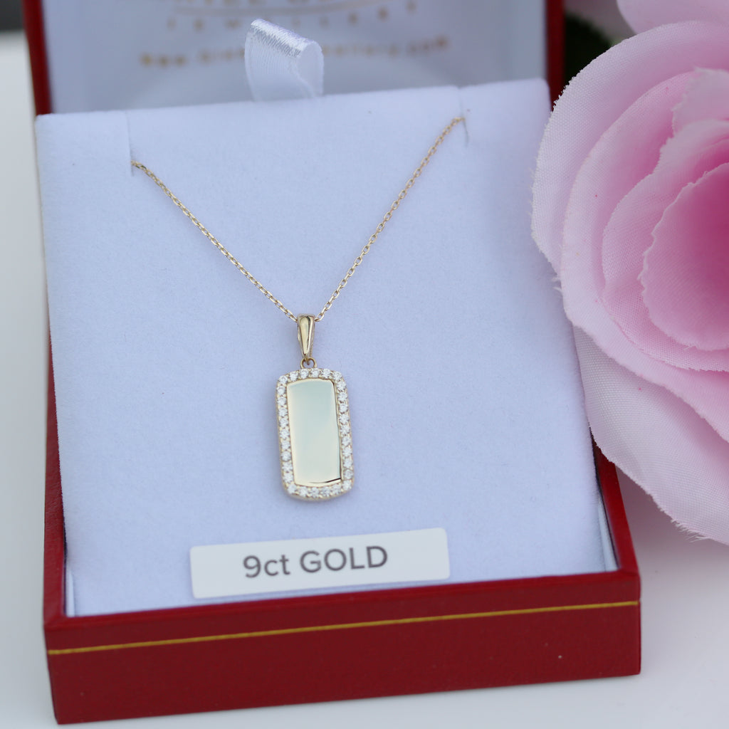 9ct gold engravable disc pendant with sparkling border and chain, displayed in jewellery box.