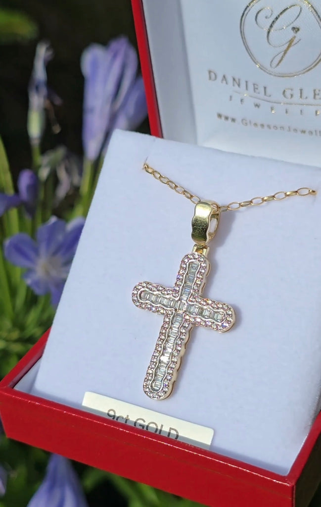 9ct gold cross pendant with baguette and round CZ stones displayed in an open red Gleeson Jewellers jewellery box with 24-inch gold chain.