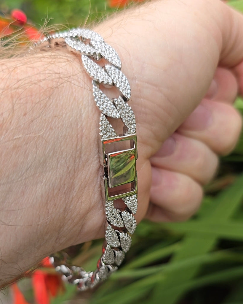 Rear wrist view of the bracelet clasp closed, showing smooth, unengraved finish of the plate.
