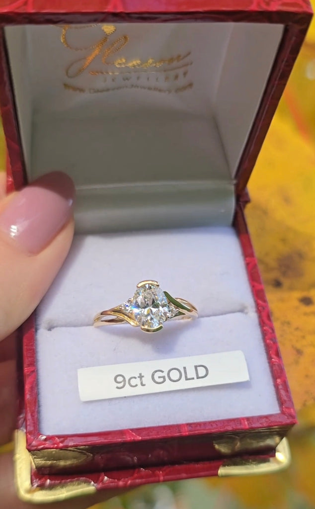 Fiadh oval-cut cubic zirconia ring in 9ct yellow gold from Gleeson Jewellers, displayed in a red presentation box with gold logo and white interior.