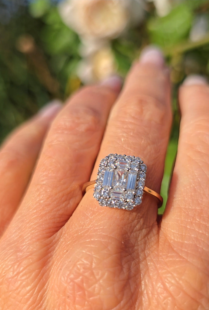 9ct gold cubic zirconia statement ring worn on a hand, showing the rectangular centre stone with halo of smaller stones.