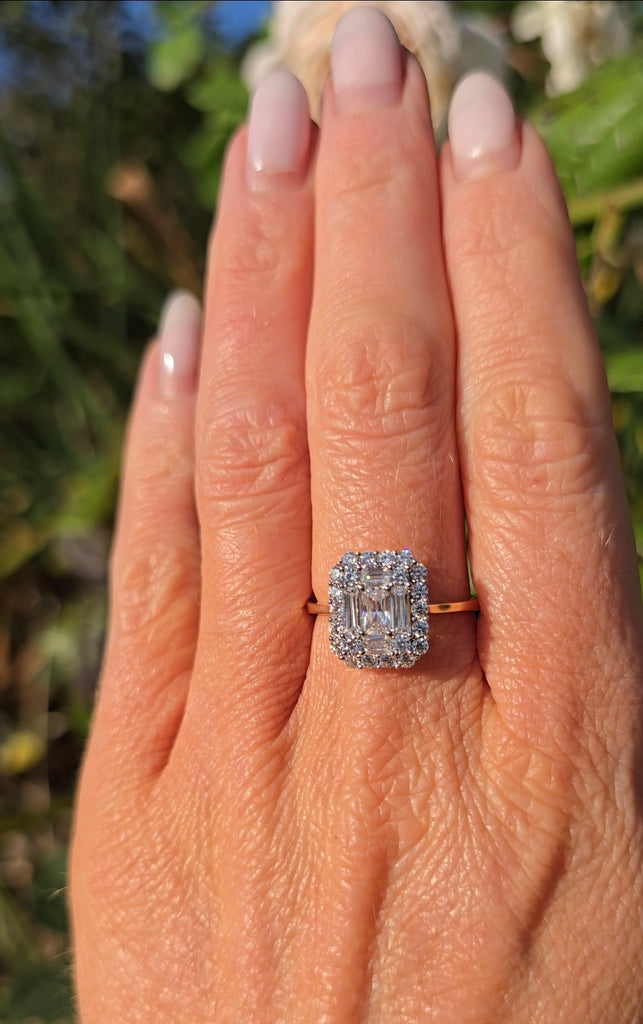 Side view of a 9ct gold cubic zirconia statement ring on a hand, sparkling in natural sunlight.
