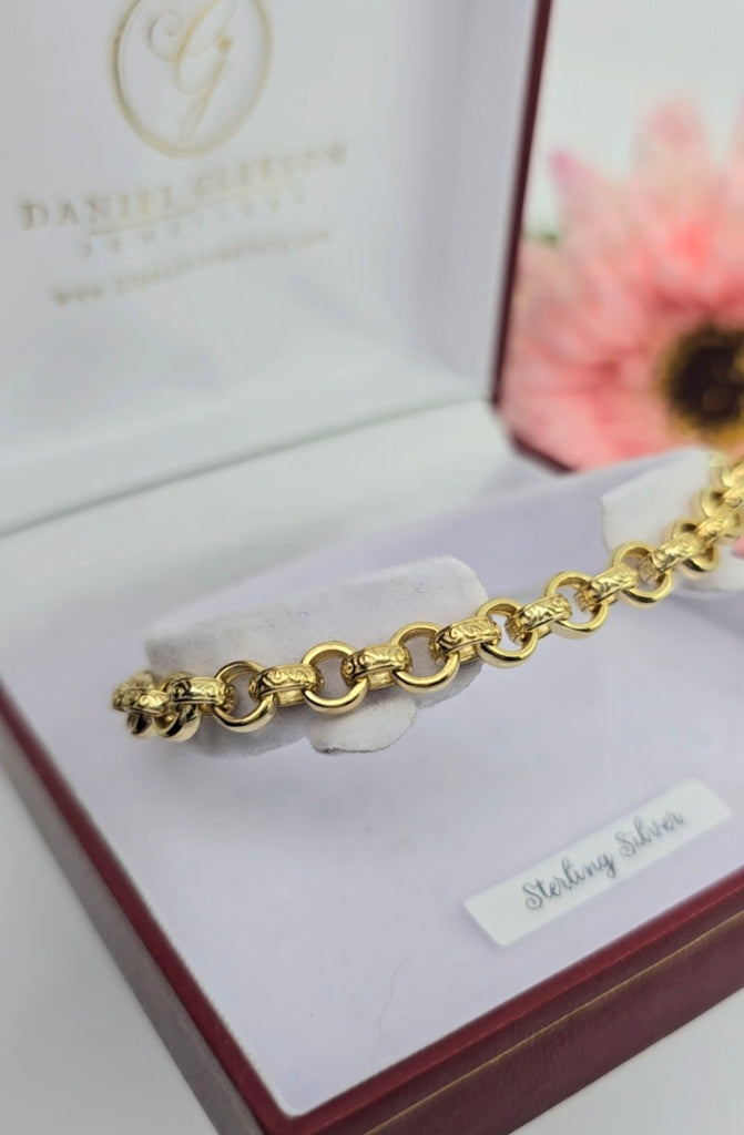 Gold on sterling silver belcher link bracelet with pink CZ stones photographed on a white jewellery cushion in a presentation box