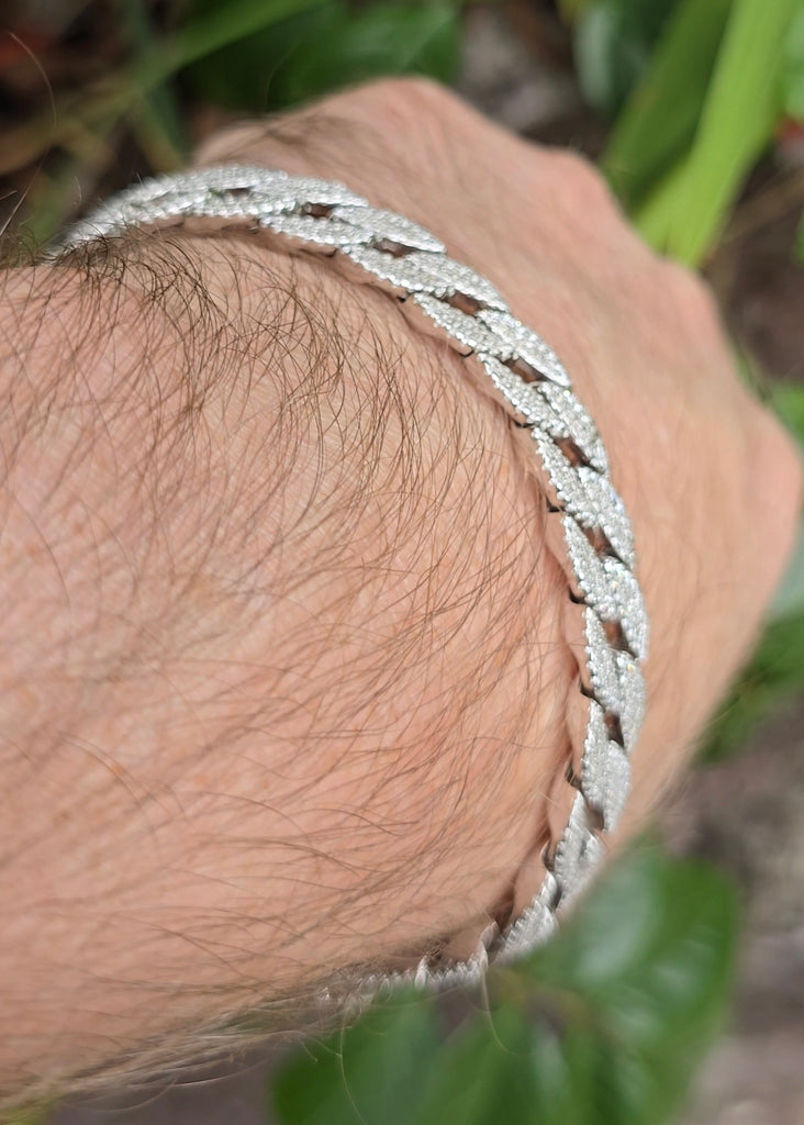 Side view of the sterling silver Cuban bracelet worn on wrist, showcasing the curve and weight of the piece.