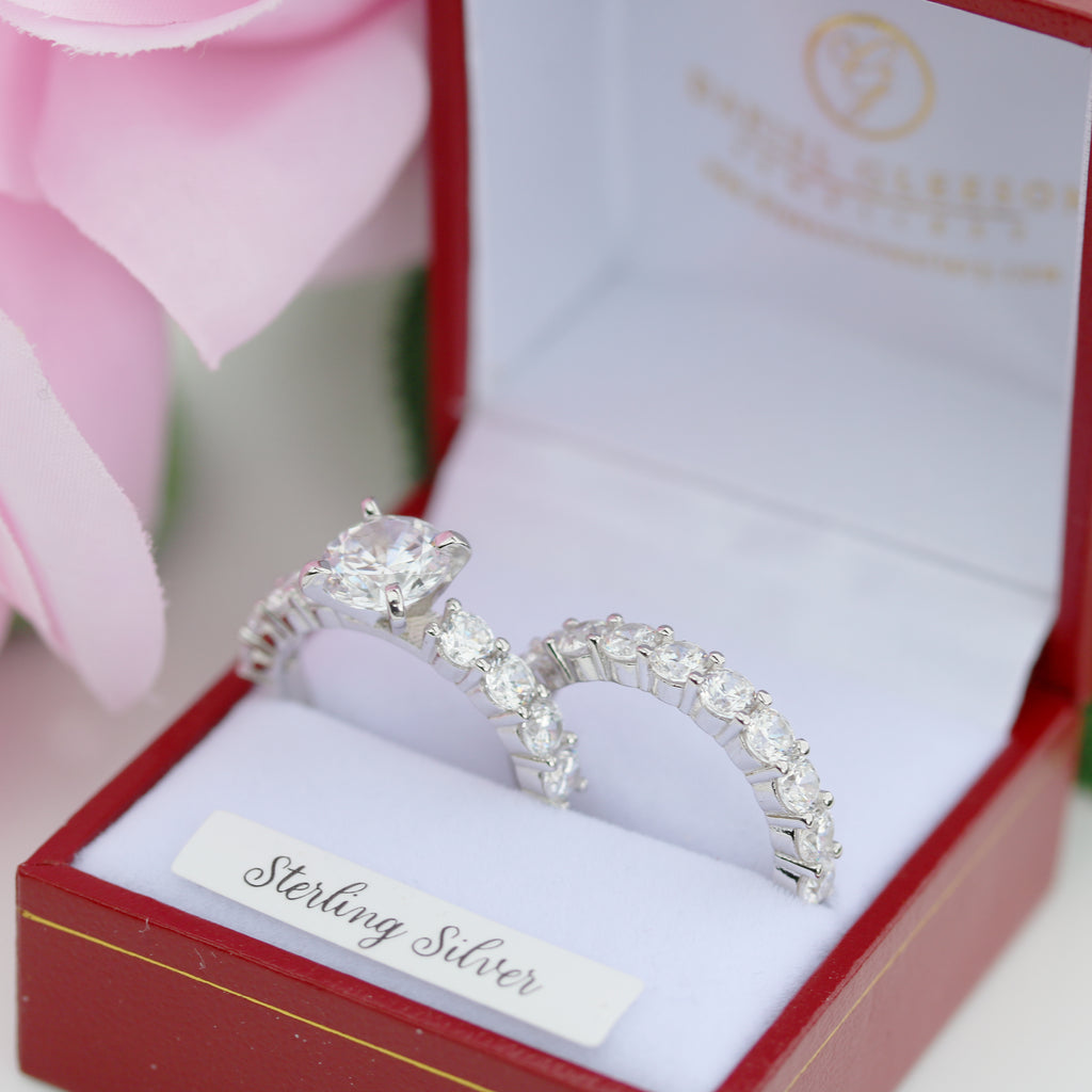 Helena sterling silver engagement and wedding ring set displayed in presentation box with pink floral accents.