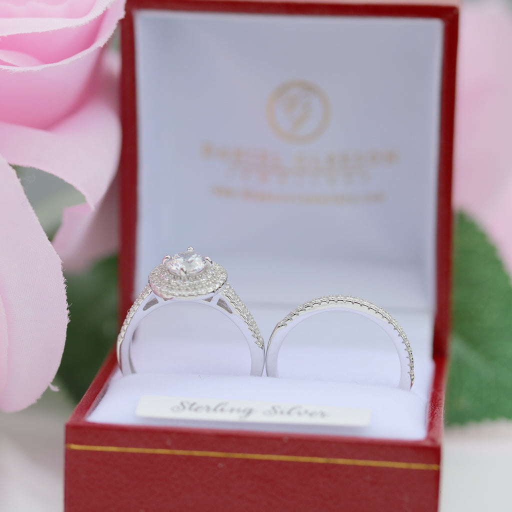 Sterling silver halo engagement and wedding band set on white background gleeson jewellers gift box.