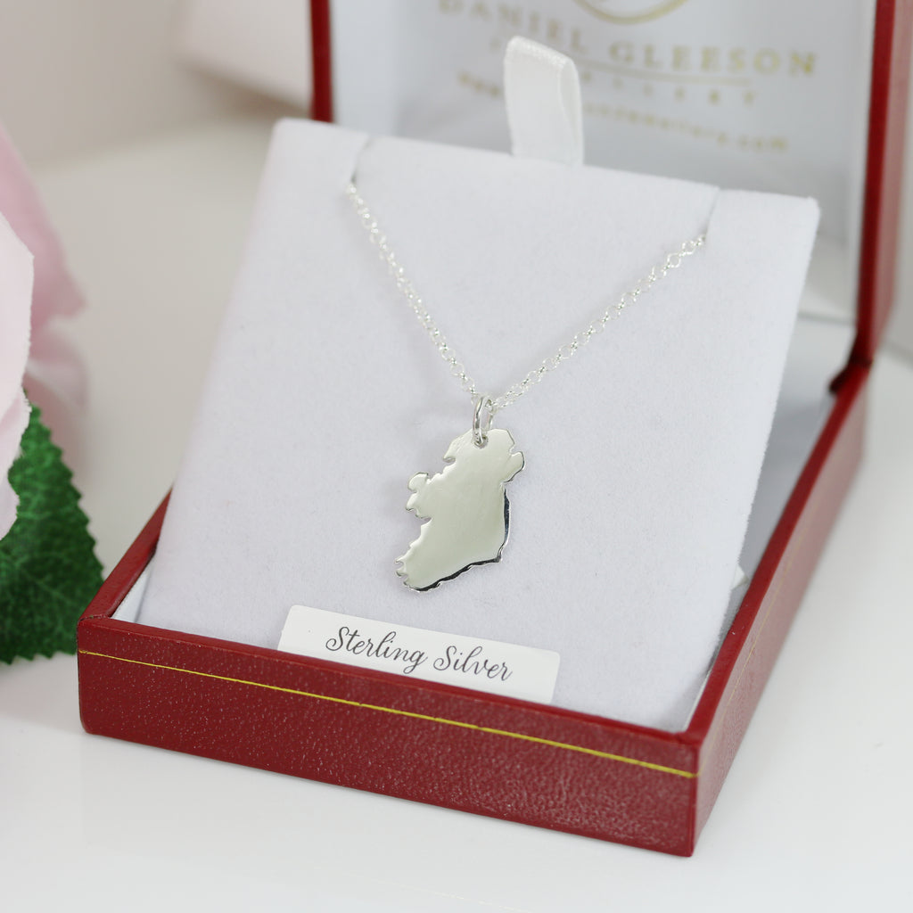 Silver Ireland map necklace shown in hand, designed by Gleeson Jewellery