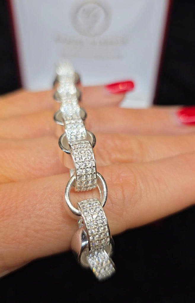 A detailed close-up of the bracelet from Daniel Gleeson Jewelers showcased atop the person’s fingernails, highlighting the bracelet's sparkle and design while providing a clear sense of its scale and elegance.
