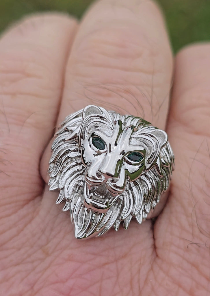 Front view of sterling silver lion ring worn on finger, displaying green cubic zirconia eyes.
Gleeson Jewellers 