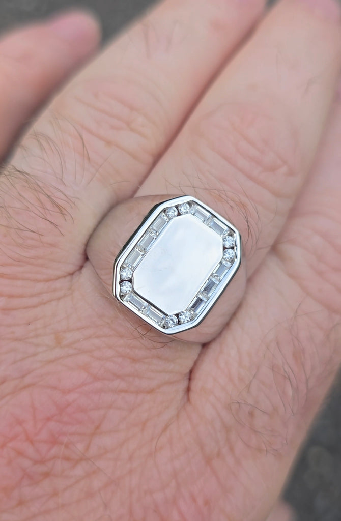 Top view of sterling silver signet ring featuring a blank face framed by baguette and round CZ stones, worn on finger. Gleeson Jewellery 