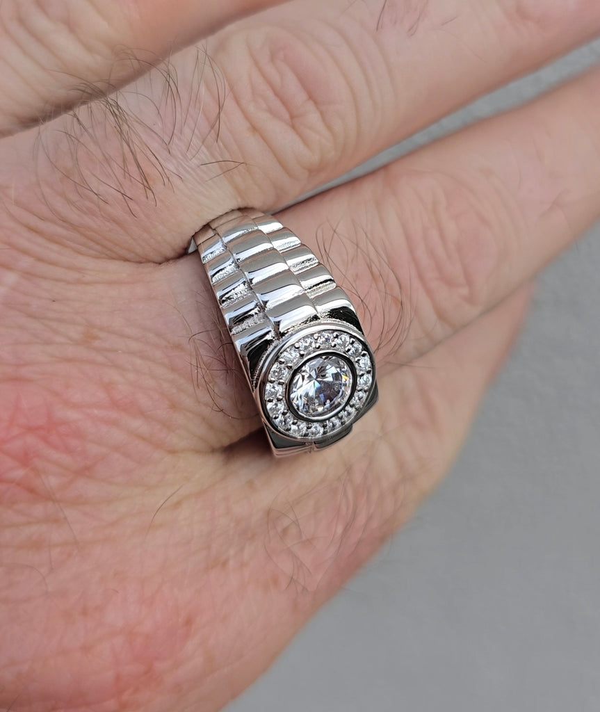 Angled close-up of sterling silver men's ring with brilliant CZ center and polished brickwork-style band from Gleeson Jewellery 