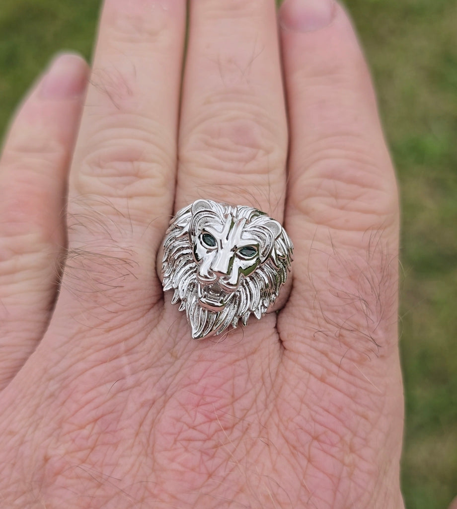 Sterling silver lion head ring worn on hand, showing size and fit from above.
