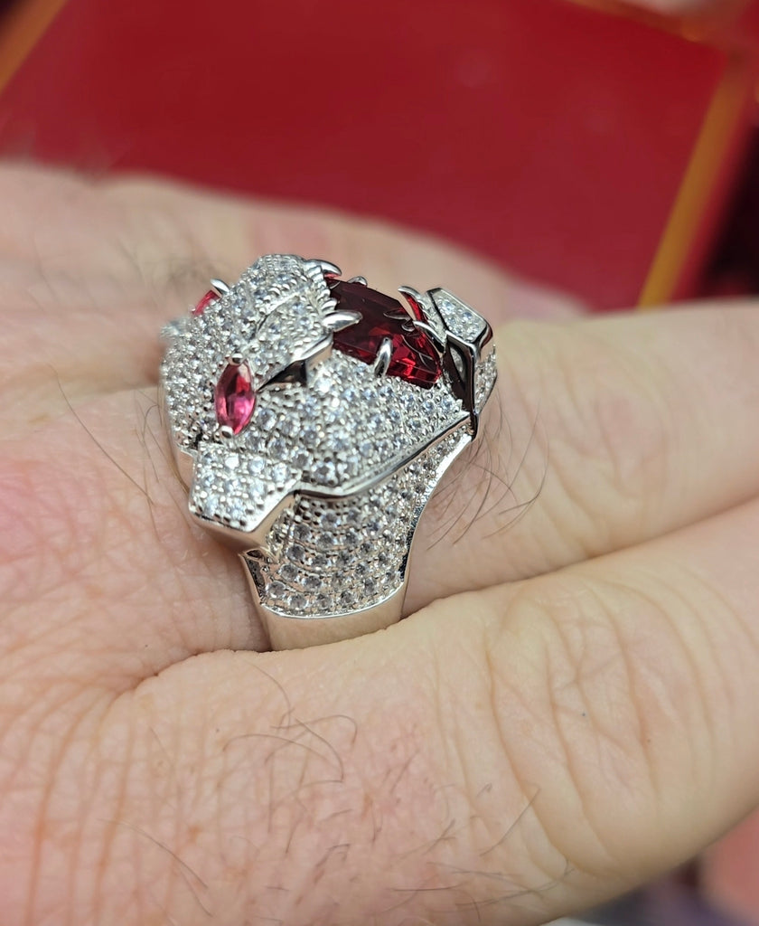Close-up of Sterling Silver men’s panther ring with ruby-red cubic zirconia eyes and mouth, worn on hand, Gleeson Jewellers.