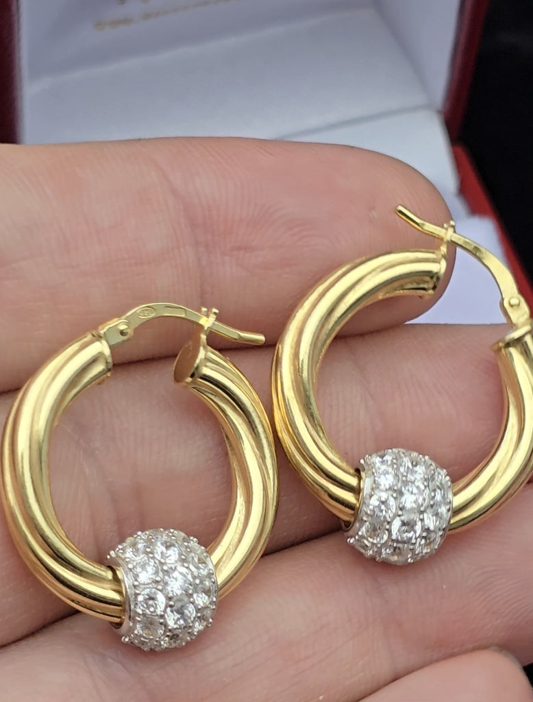 In man's hand size of hoop 925 earrings and ball