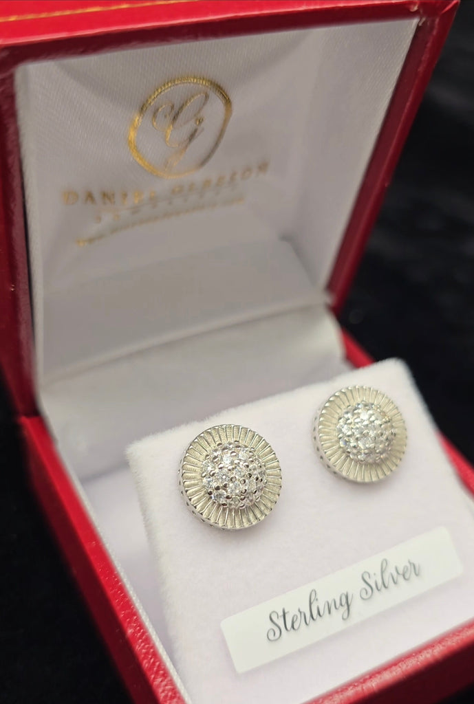 Sterling Silver medium-sized rolex inspired disc stud earrings with centre pave cubic zirconia from Daniel Gleeson Jewellers Cork displayed in a red earrings gift box