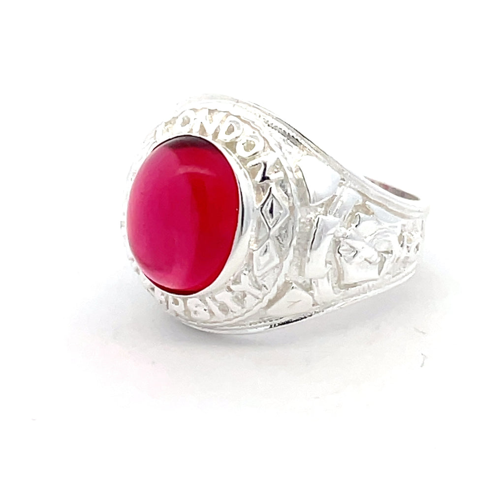 Men’s sterling silver college ring with bold oval red stone, shown at an angle.