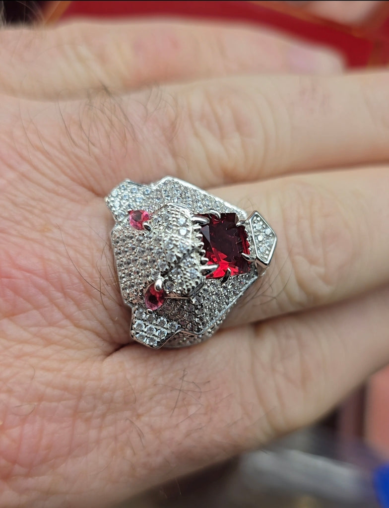 Close-up of Sterling Silver men’s panther ring with ruby-red cubic zirconia eyes and mouth, worn on hand, Gleeson Jewellers.