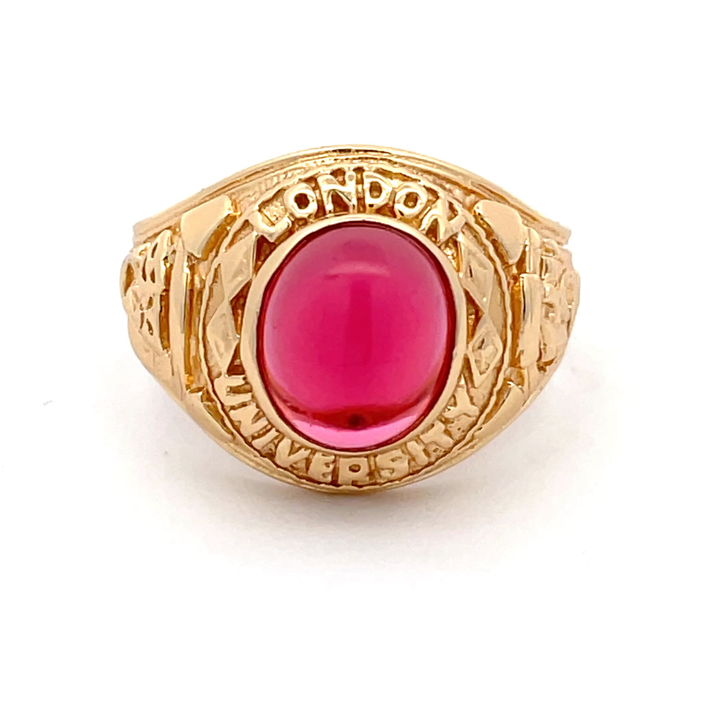 Front view of men’s sterling silver gold-plated college ring with red stone centrepiece.