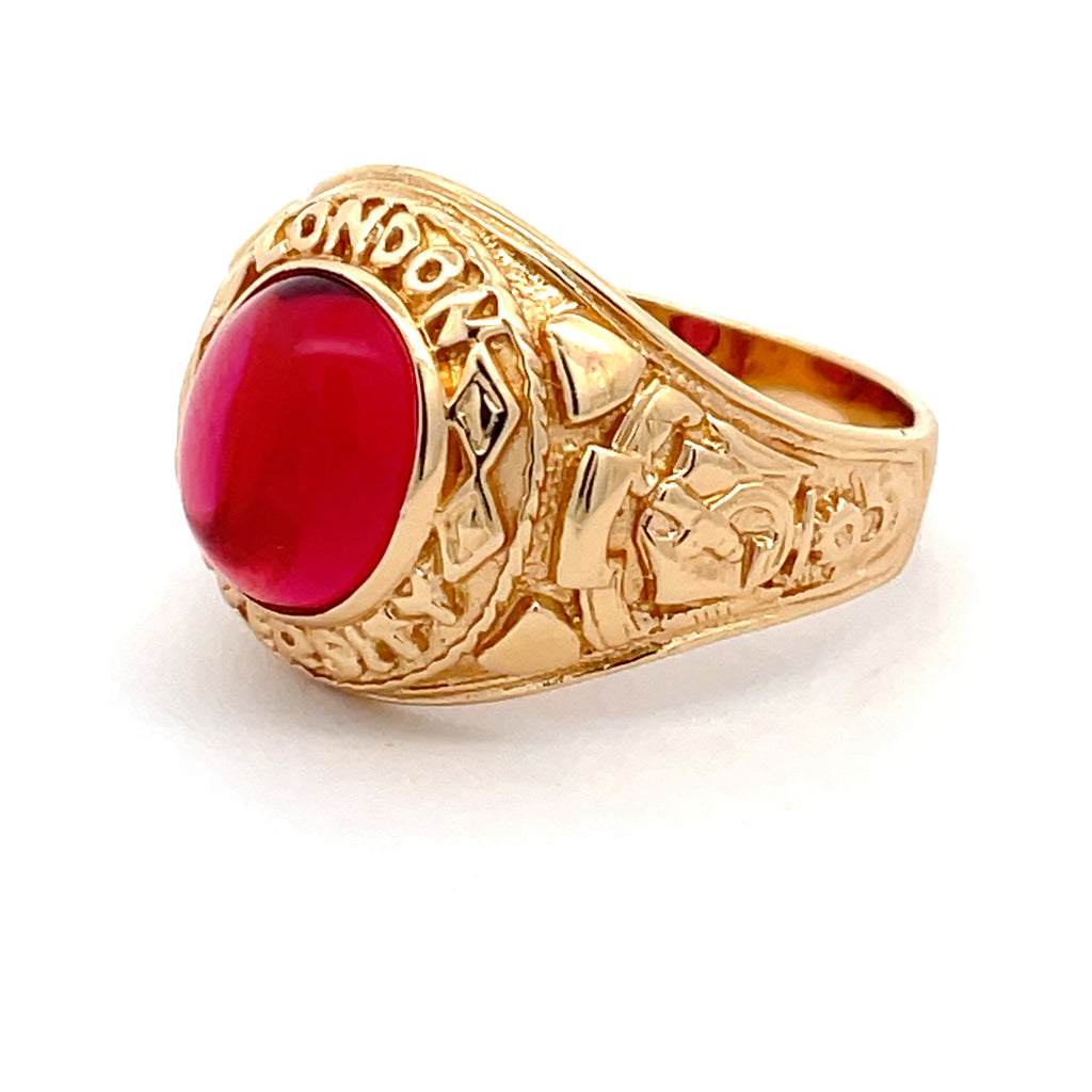 Men’s sterling silver college ring with gold-plated finish and oval red stone, shown at an angle.