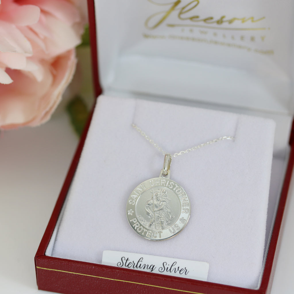 Sterling silver Saint Christopher medal pendant displayed in a red and white jewellery box, featuring an intricate engraving and an 18-inch chain