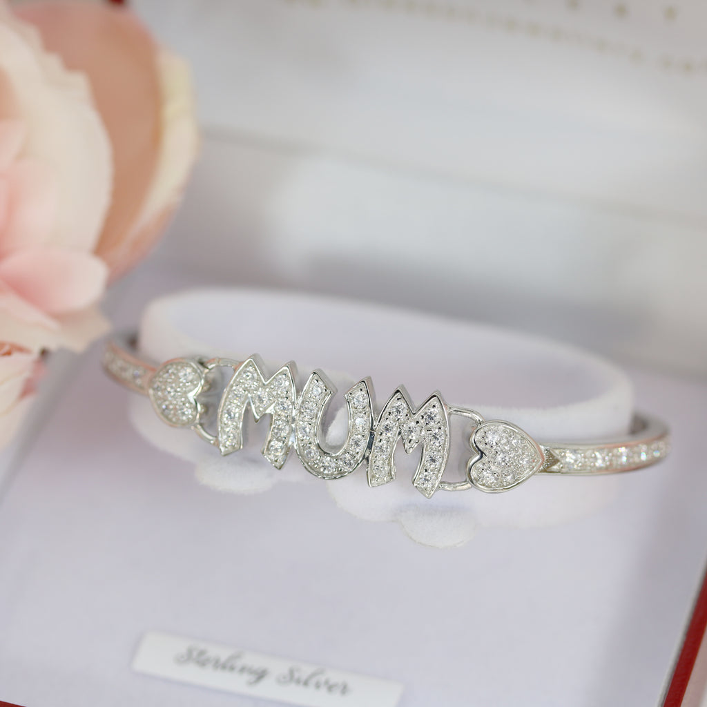 Sterling silver Mum bangle encrusted with cubic zirconia, displayed in a luxurious red and white jewelry box with heart accents on each side