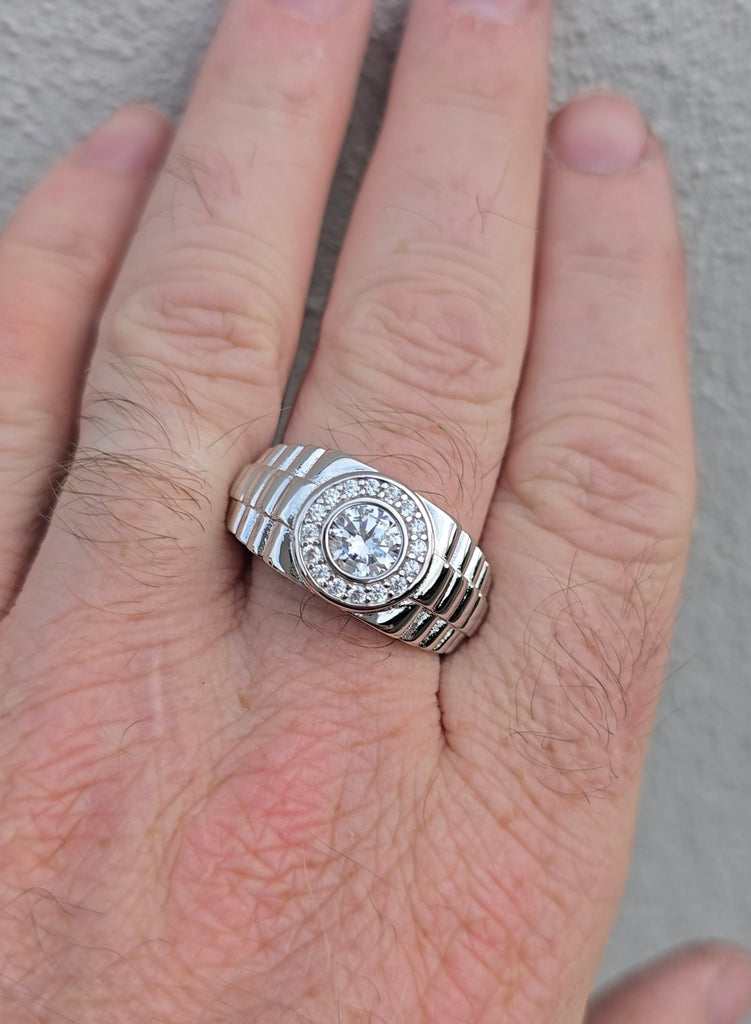 Top-down view of sterling silver men’s ring on hand, showing full face and structured link-style band design.
Gleeson Jewellers 