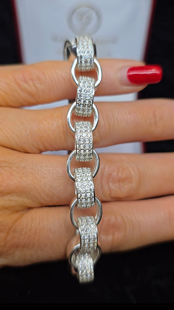 A photograph showing the bracelet from Daniel Gleeson Jewelers being held delicately between two fingers, with the person’s polished nails visible in the background, illustrating the bracelet's size and design.