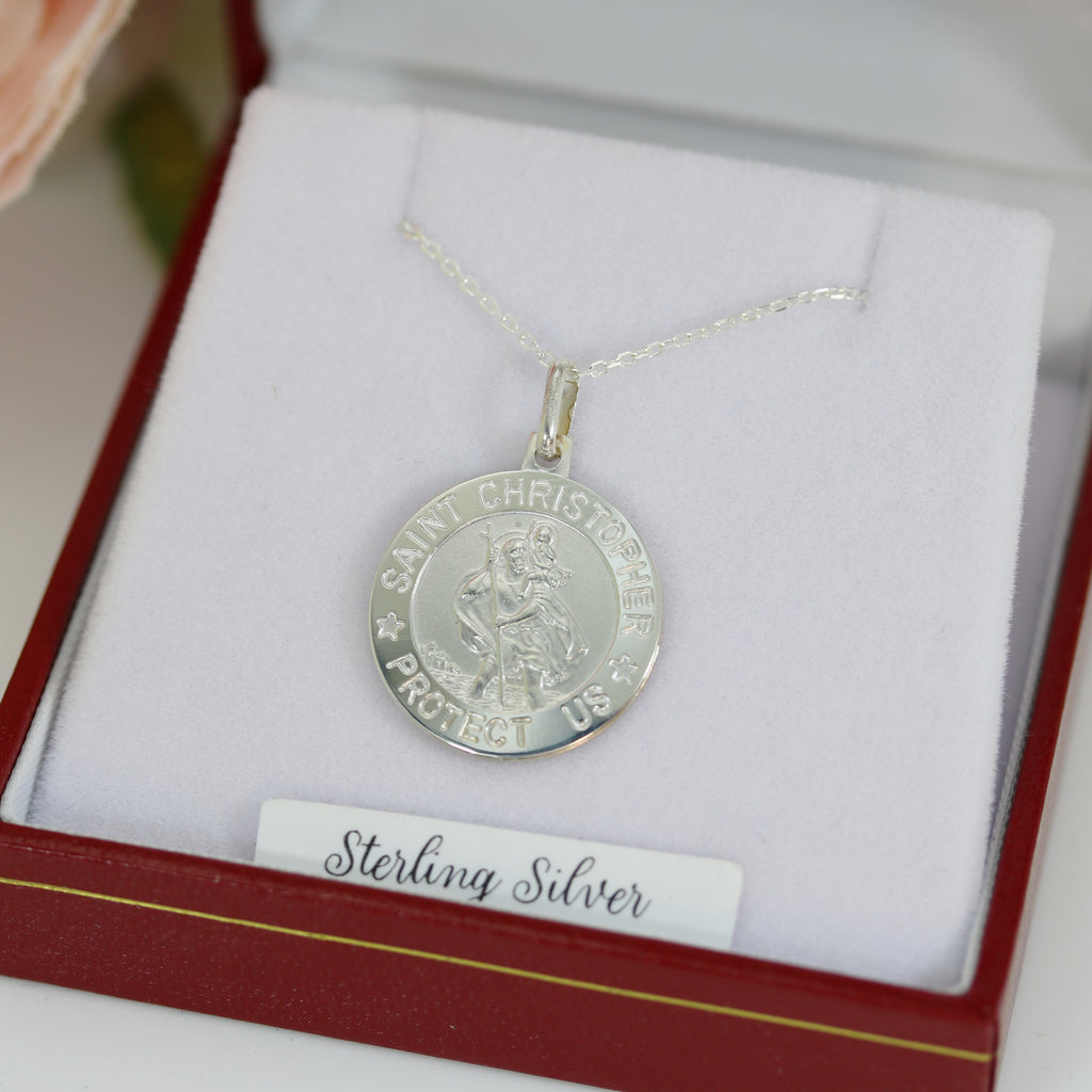 Elegant Saint Christopher pendant in sterling silver, resting in a luxury jewelry box with an 18-inch silver chain, symbolizing protection and safe travels