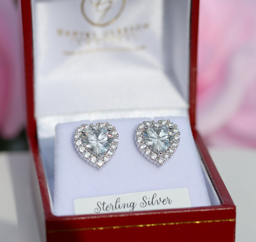 Dazzling heart-shaped cubic zirconia halo stud earrings in sterling silver, displayed in a Gleeson Jewellery gift box. Available to order online