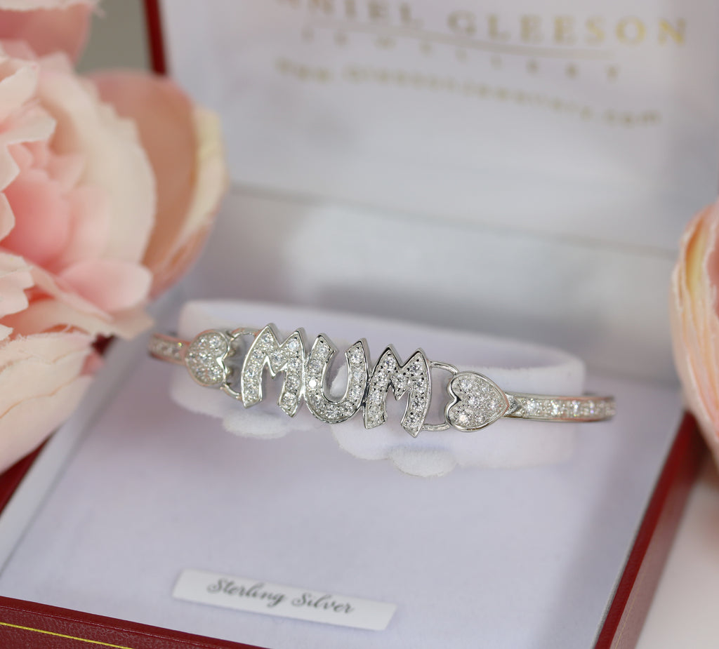 Sterling silver cubic zirconia Mum bangle bracelet displayed in a red jewellery box, highlighting its intricate design and polished finish