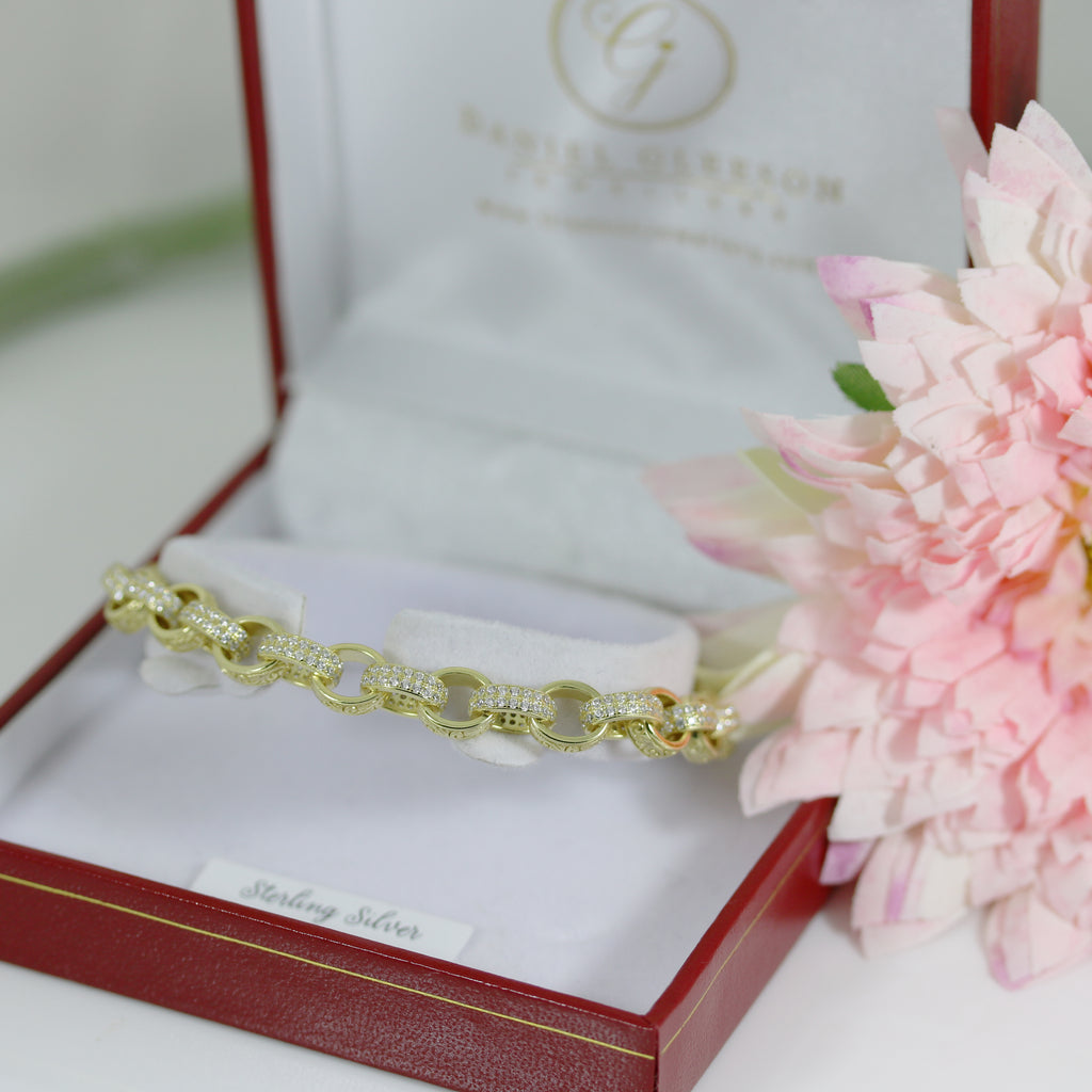 Gold-plated sterling silver CZ oval-link belcher bracelet displayed in a red Gleeson Jewellers gift box with white interior.