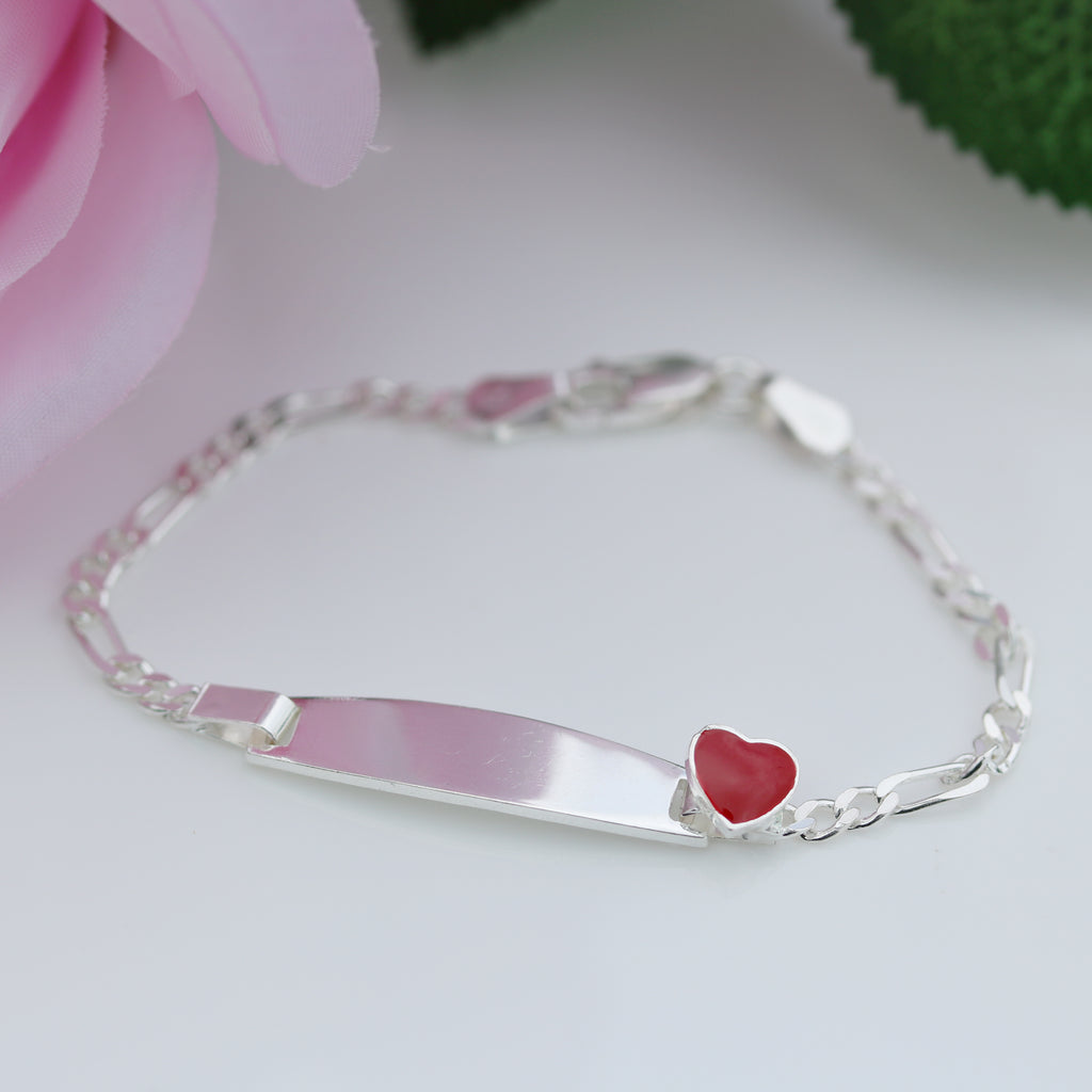 Sterling silver Figaro chain kids bracelet with engraved plate and red heart accent, photographed on a white background, from gleeson jewellers