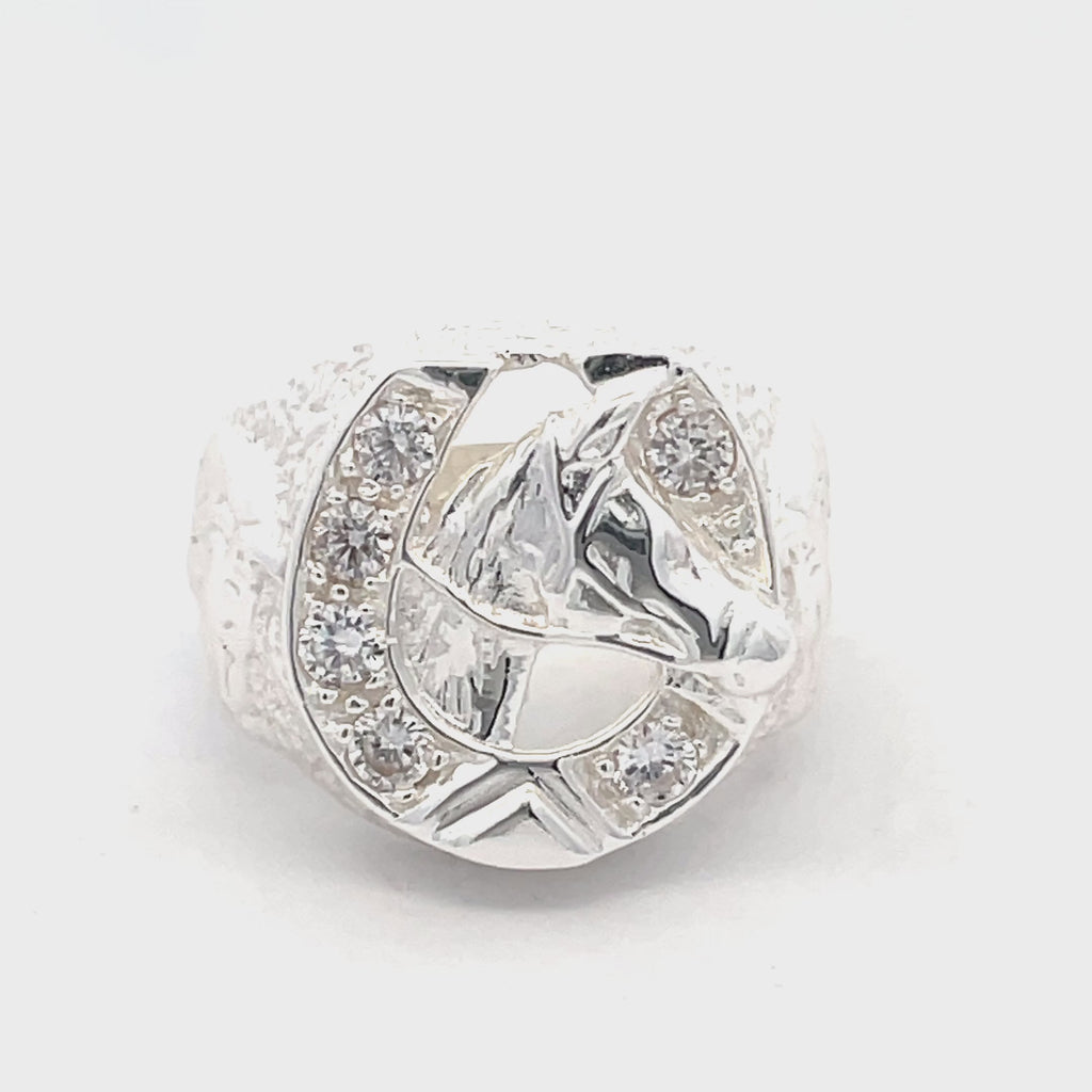 Overhead view of sterling silver men’s horseshoe head ring featuring horse design and stone-set horseshoe from Gleeson Jewellers.