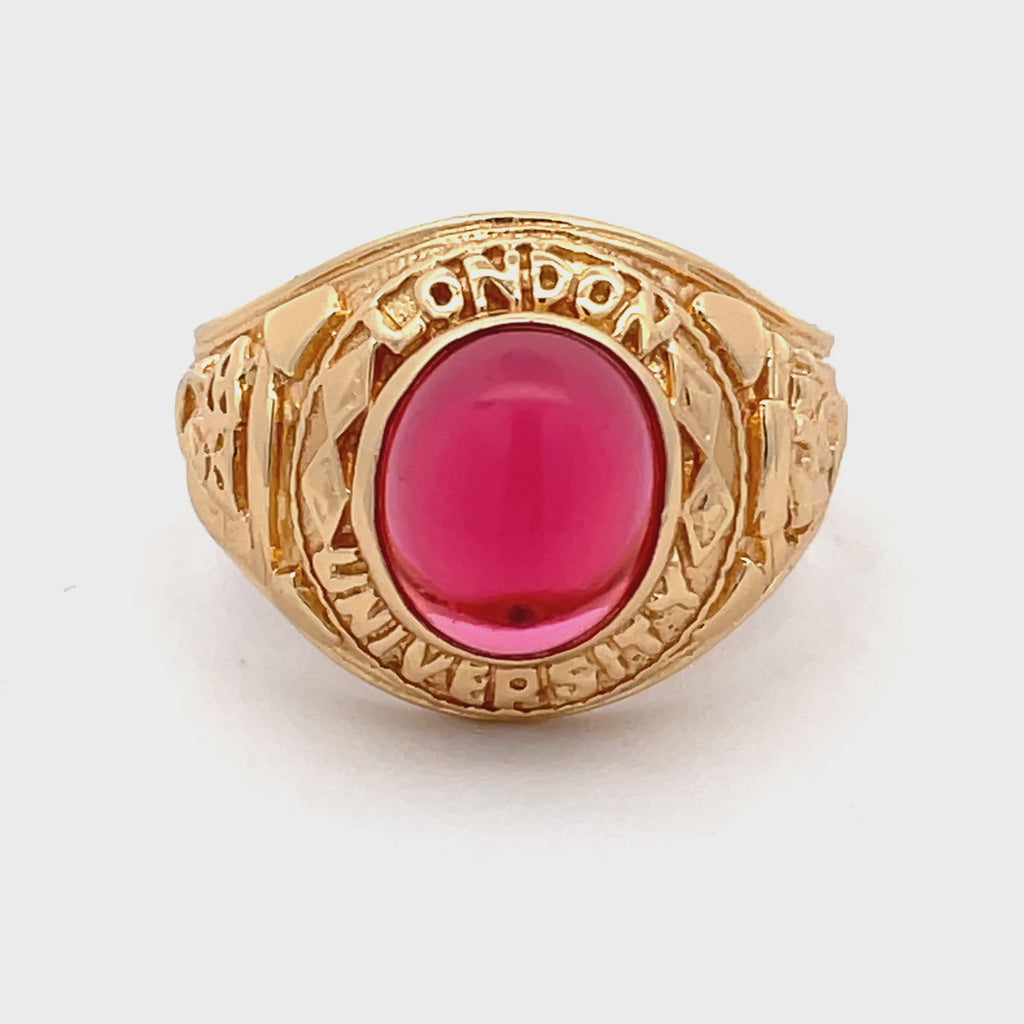 Overhead view of sterling silver gold-plated men’s college ring with engraved detailing and deep red stone from Gleeson Jewellers.