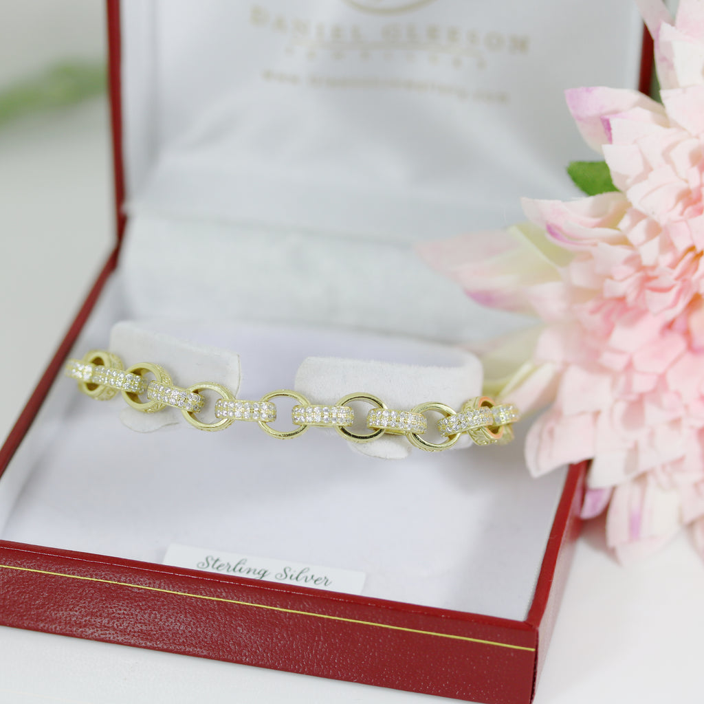 Elegant presentation of the CZ oval-link belcher bracelet in a red Gleeson Jewellers box, styled with soft pink flowers.