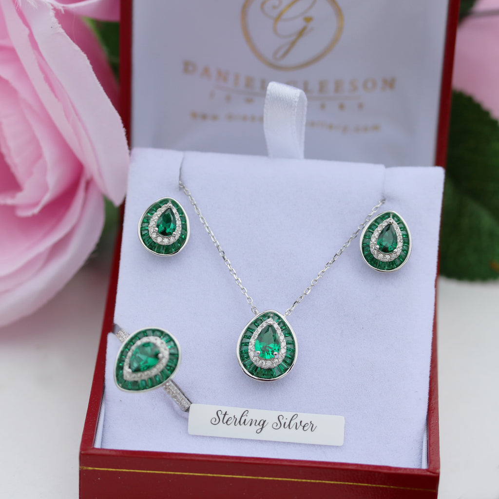 Green gemstone jewelry set with 'Sterling Silver' label in a Gleeson Jewellery box.