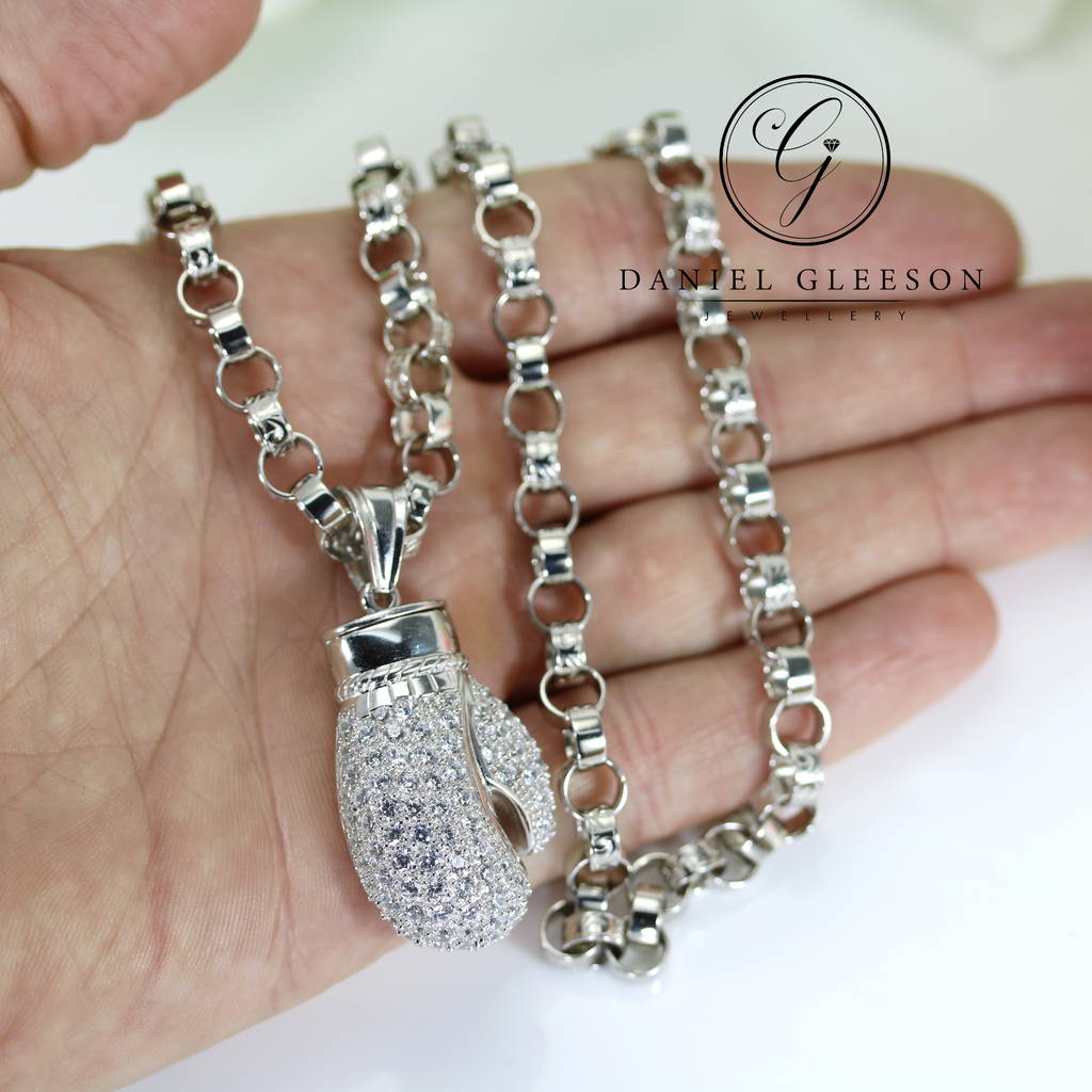 large boxing glove pendant on a 20" heavy chain, pictured in the hand for size context in daniel gleeson jewellers cork