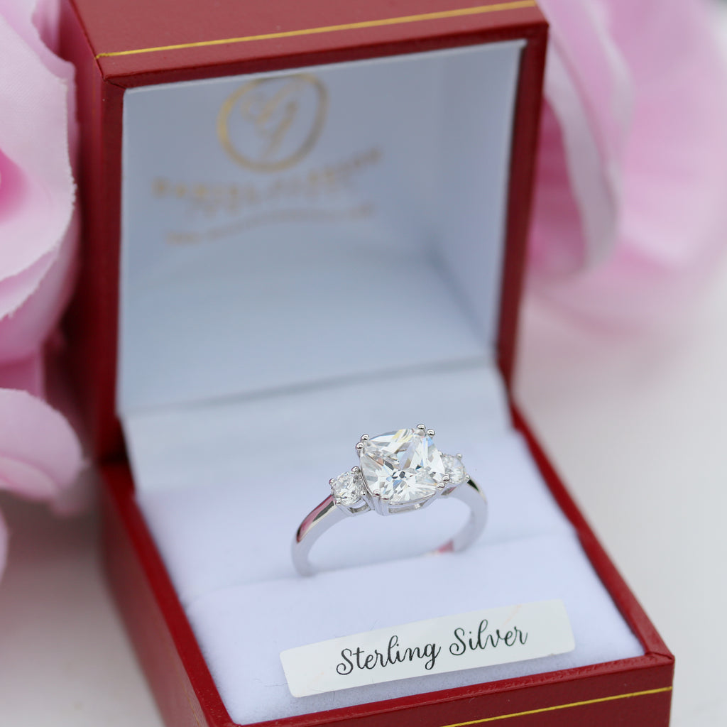  Angled view of the sterling silver trilogy CZ ring in a red ring box with the Gleeson Jewellers logo visible inside the lid.