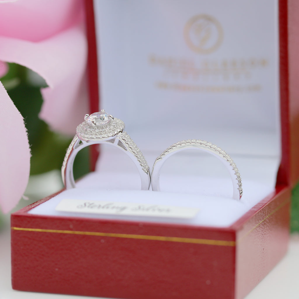 Sterling silver halo engagement ring set with cubic zirconia, elegantly displayed in presentation box.