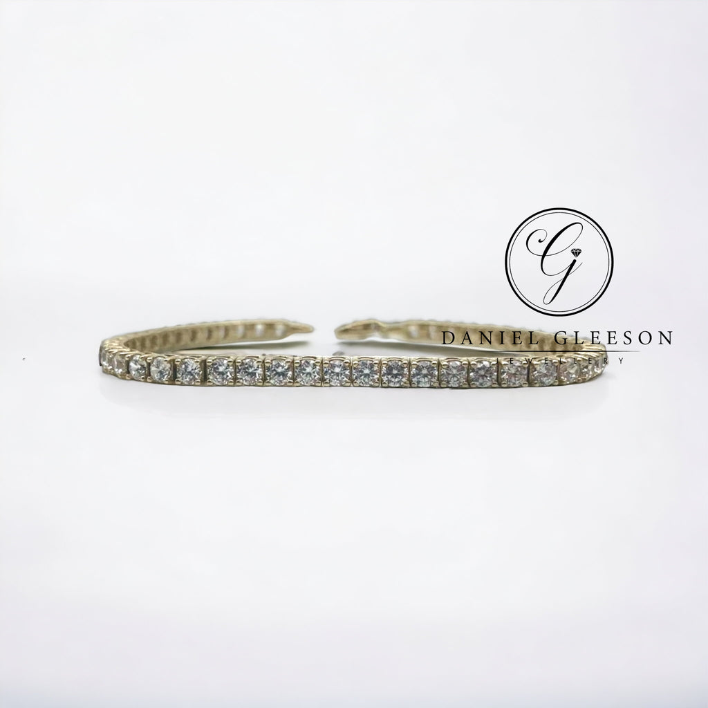 Yellow gold tennis bracelet displayed flat on white surface from daniel gleeson jewellers cork